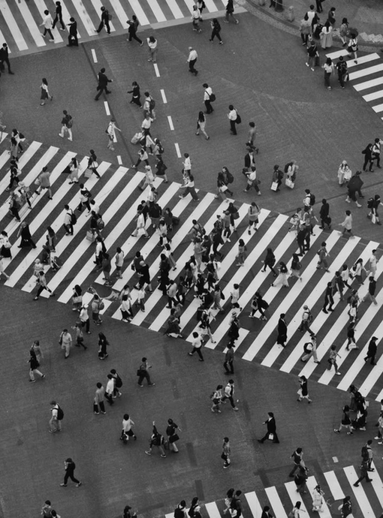 Blog poster crossing the street in a square in Japan.